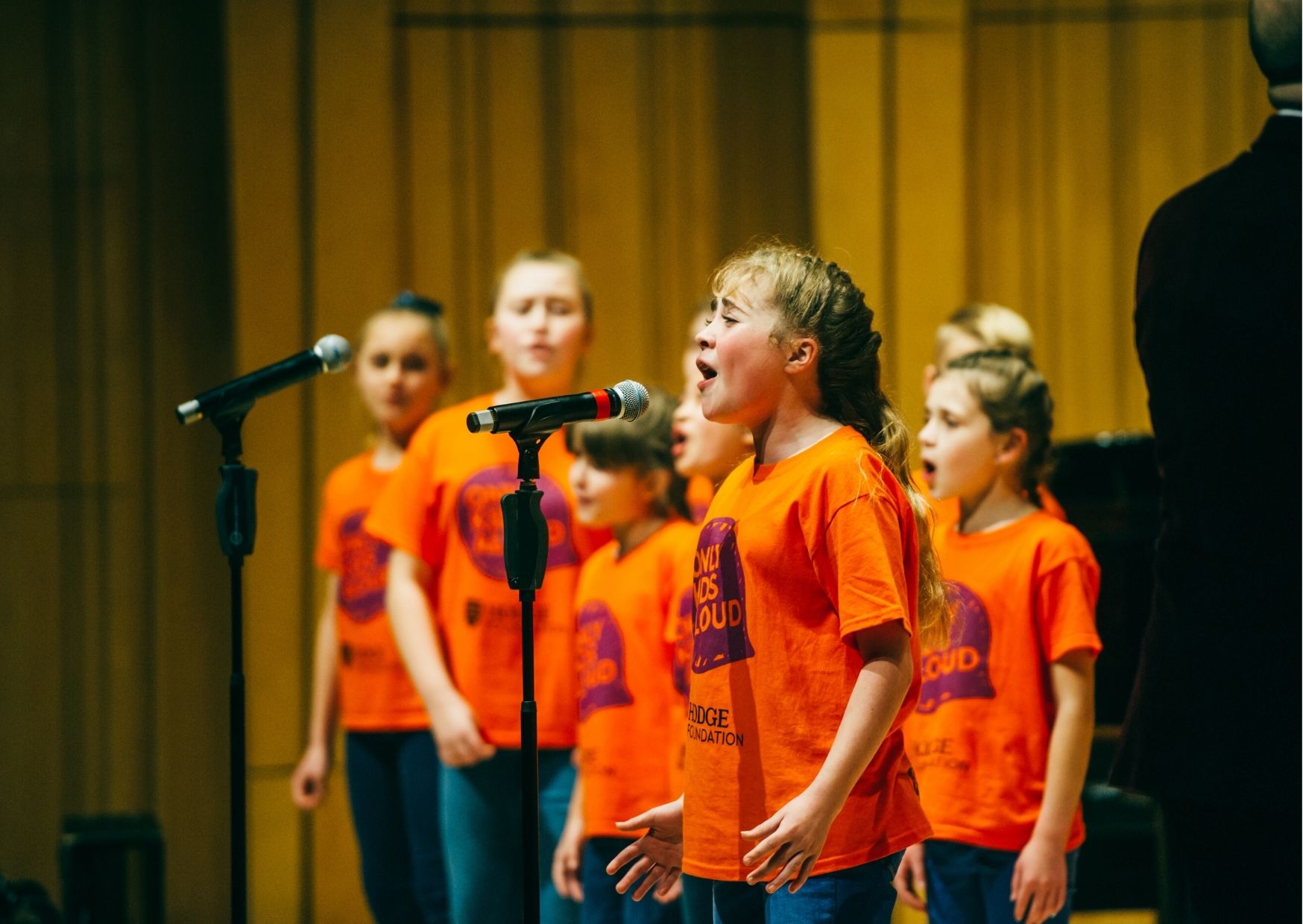 Young Girl Singing into a microphone