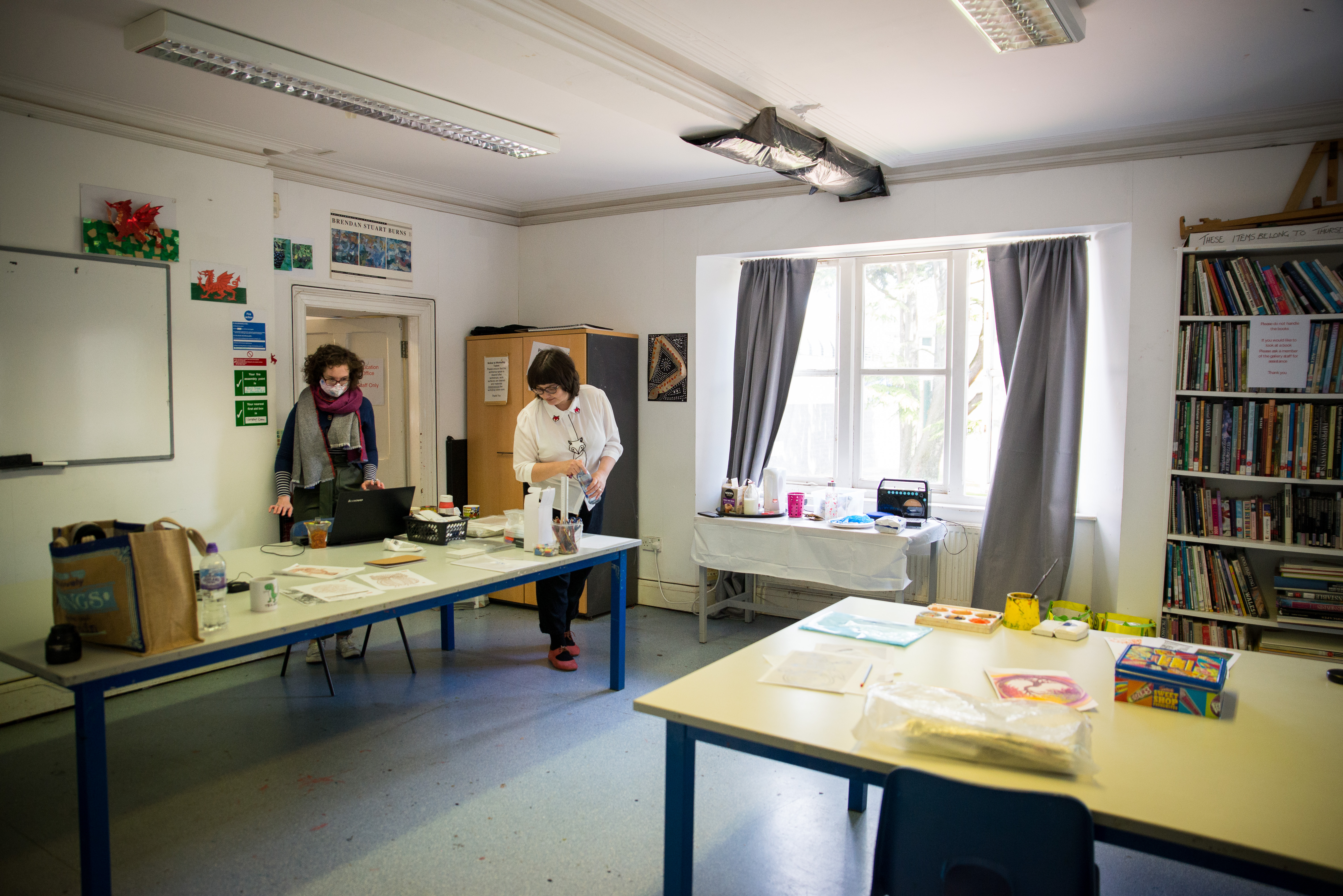 A view of our education workshop, featuring two staff members setting up a class.