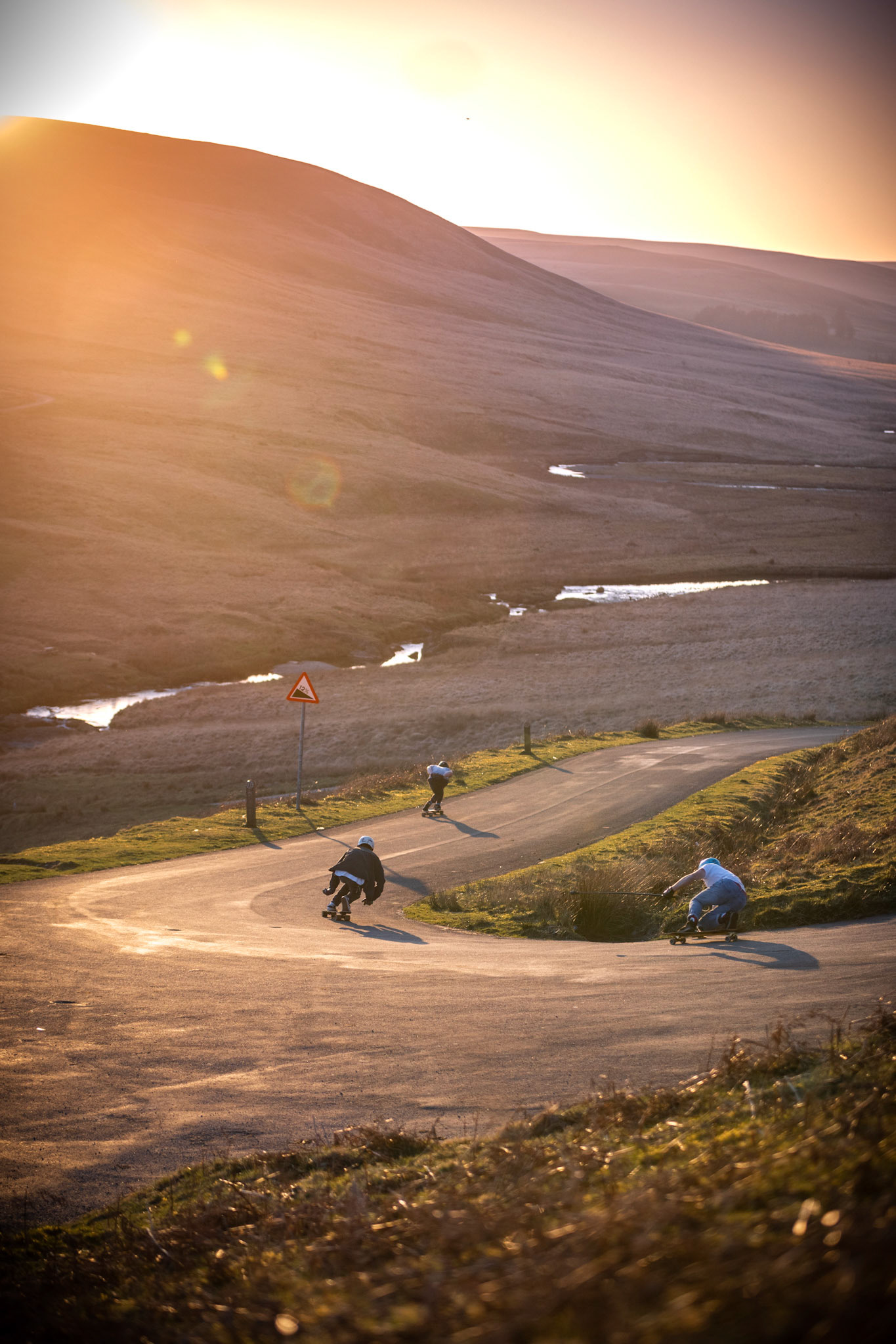 Action shot of skateboarders going down a hill