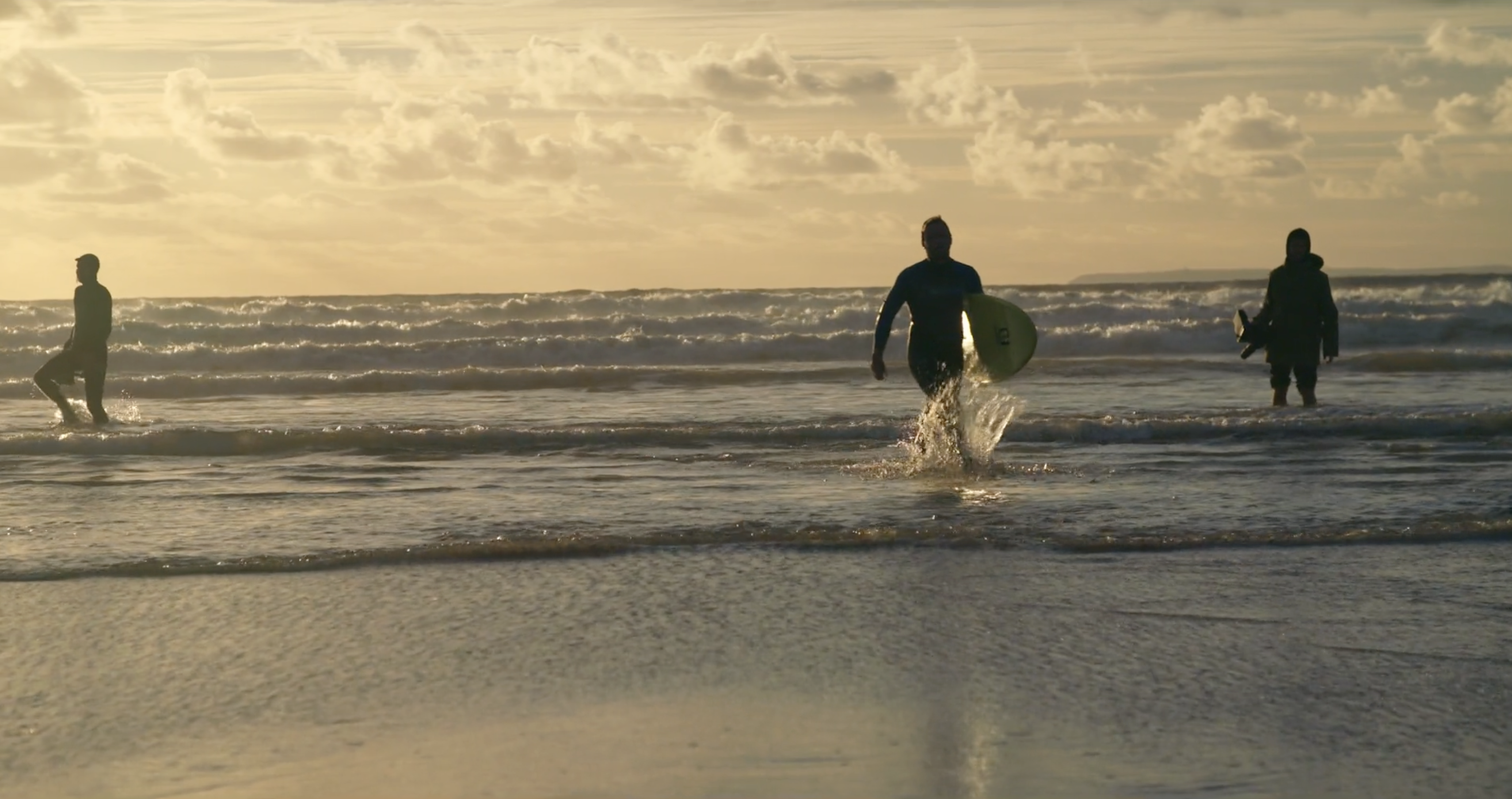 Surfers at sunset