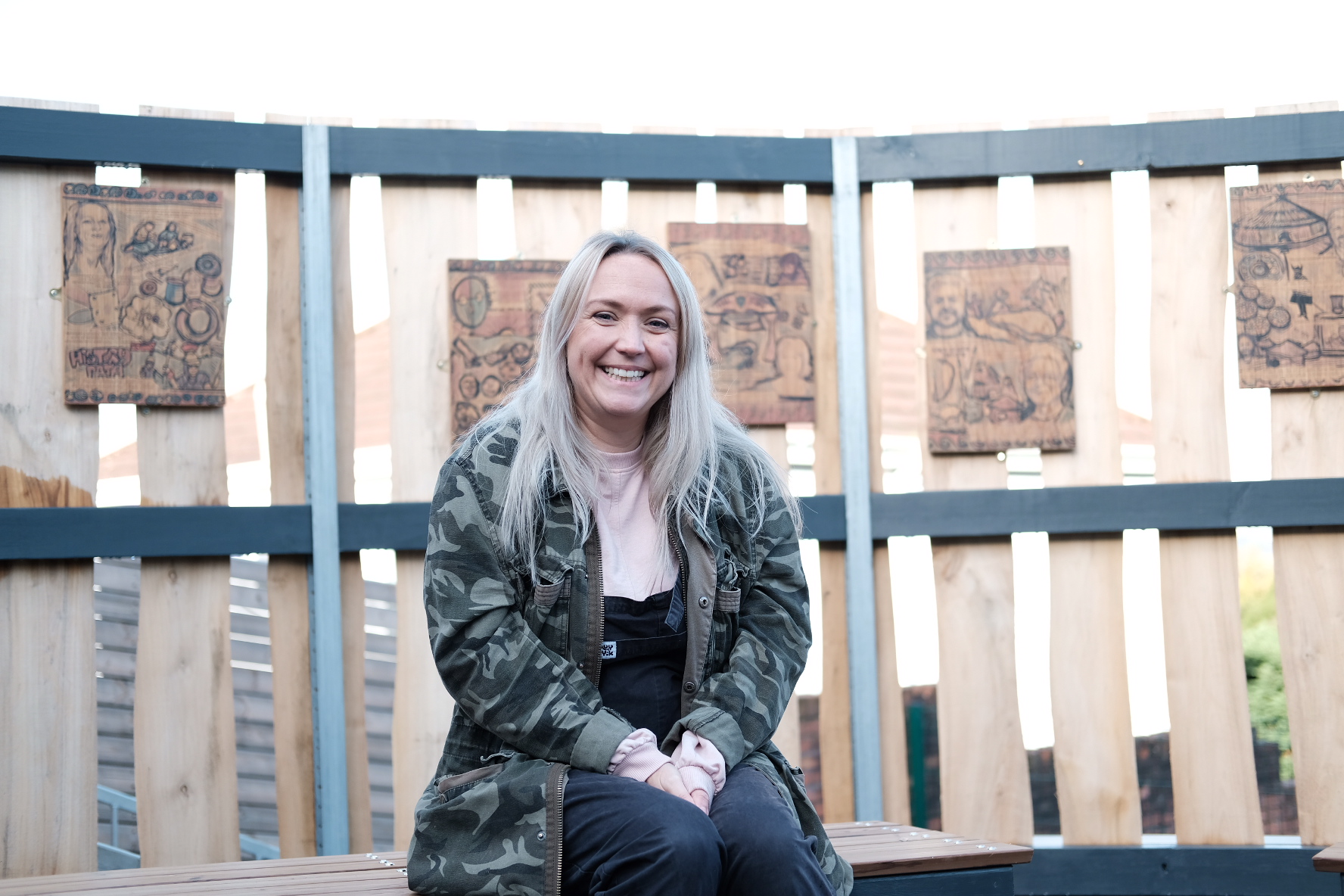 Nic Parsons sitting on a bench at the CAER Heritage Centre