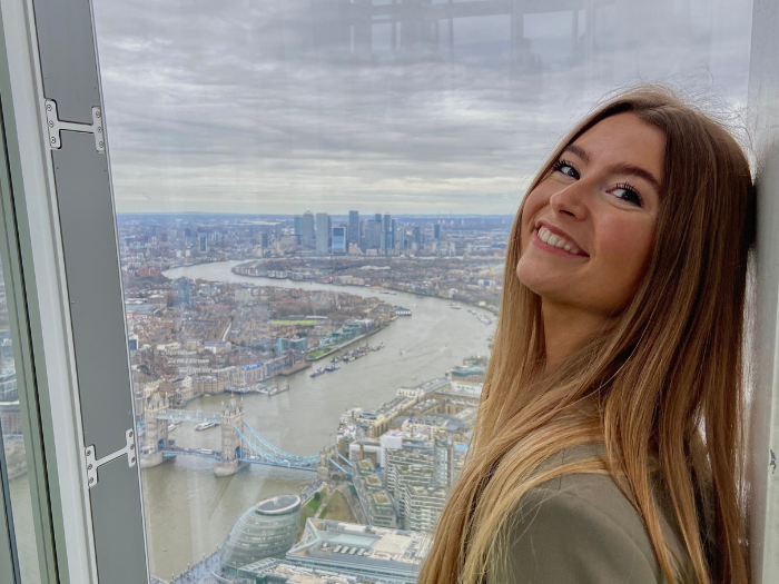 Picture of Ffion standing in front of tall buildings in London 