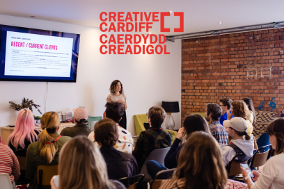 Room full of people at creative cuppa listening to a talk